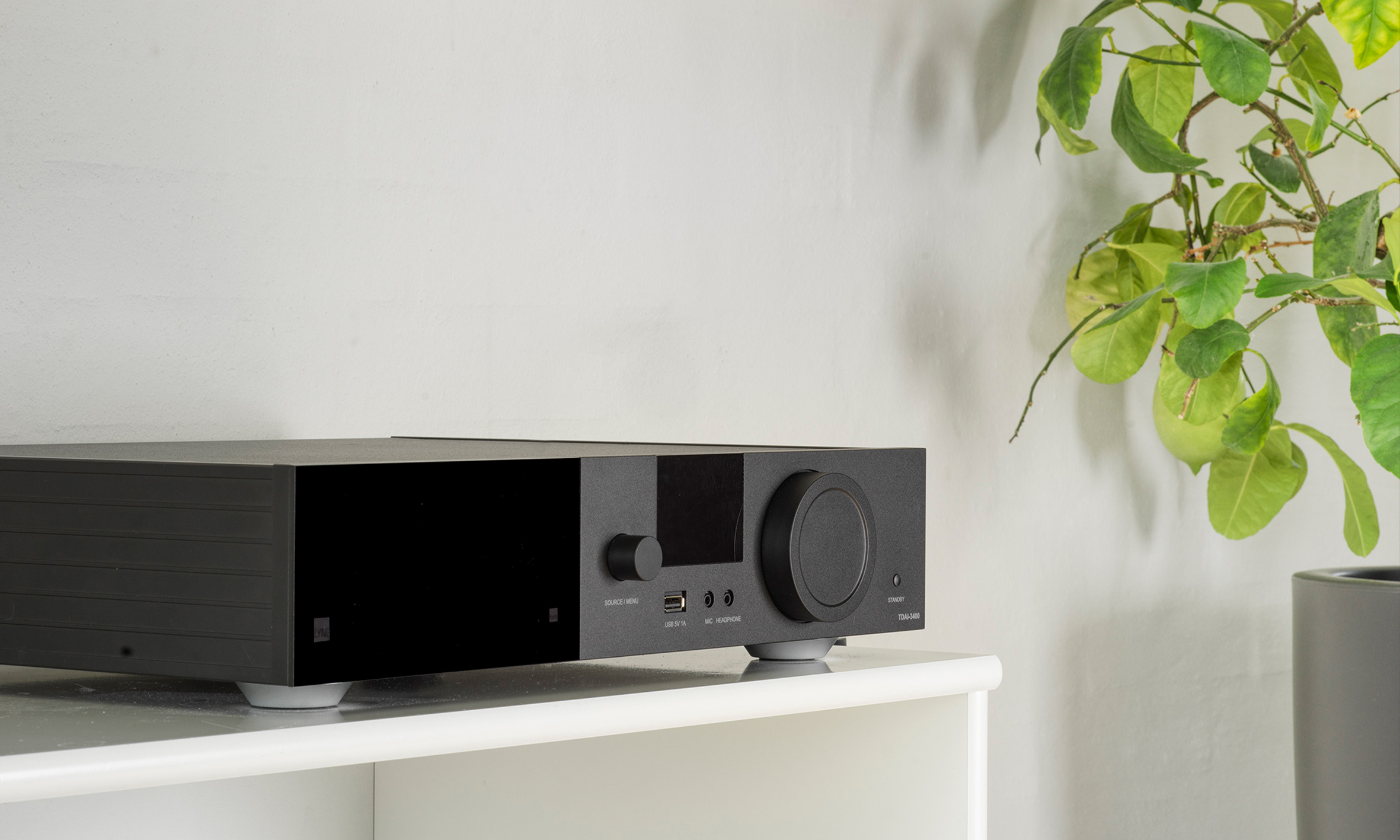 TDAI-3400 amplifier on a white furniture